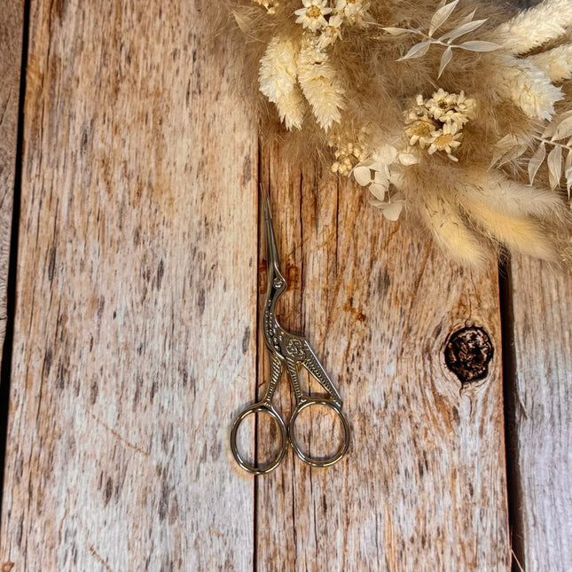 Small crane scissors in three different colors.